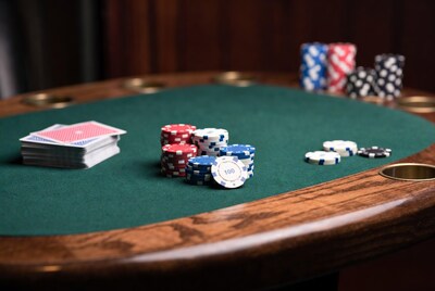 Poker chips and cards on green table
