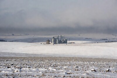 Grain silos in snowy field