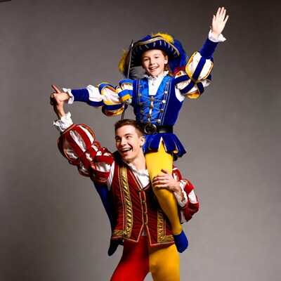 Boy piggybacking girl in Renaissance costumes