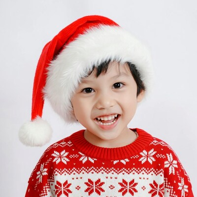 Asian boy smiling in Santa hat