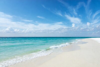 Turquoise waves on white sand beach