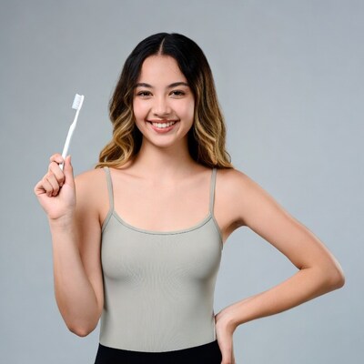 Asian girl holding toothbrush smiling