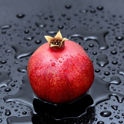 Red pomegranate with water droplets