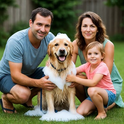 Family bathing golden retriever in backyard