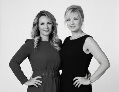 Two women in black dresses posing