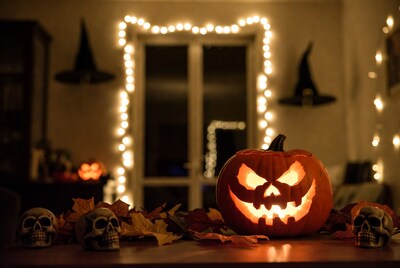 Lit Jack-o-Lantern with Skulls and Leaves