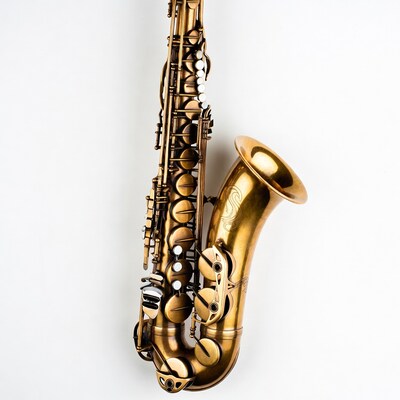 Golden sax hanging on white wall