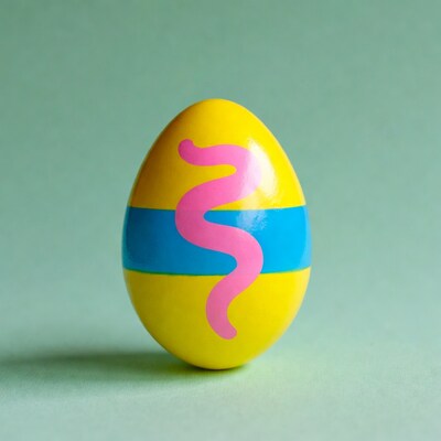 Yellow Easter egg with pink worm