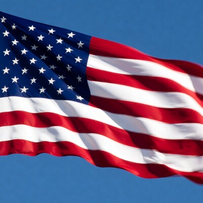 American flag waving against blue sky