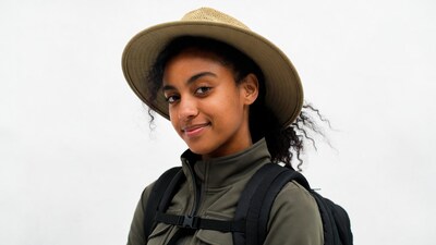 African-American woman in straw hat backpack