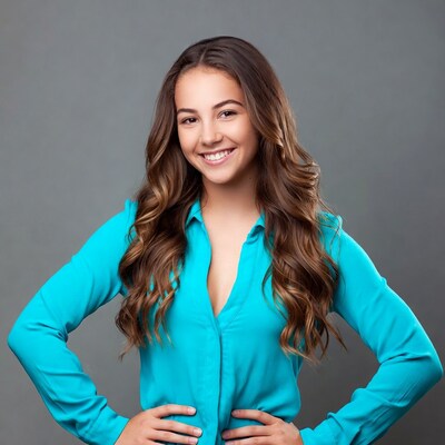 Smiling girl in turquoise blouse