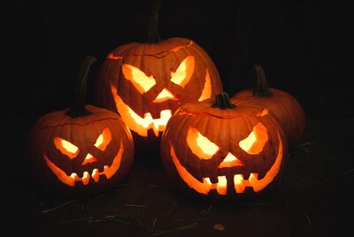 Four lit jack-o-lantern pumpkins