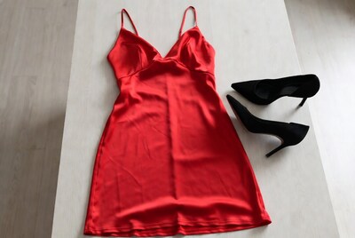 Red satin slip dress with black heels