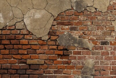Peeling Plaster on Red Brick Wall