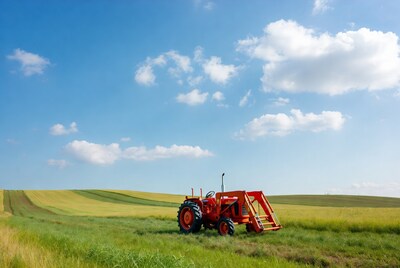 Red tractor in green field