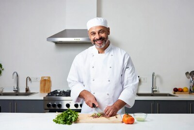 Chef cutting vegetables on kitchen counter
