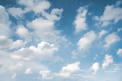 Fluffy white clouds in blue sky