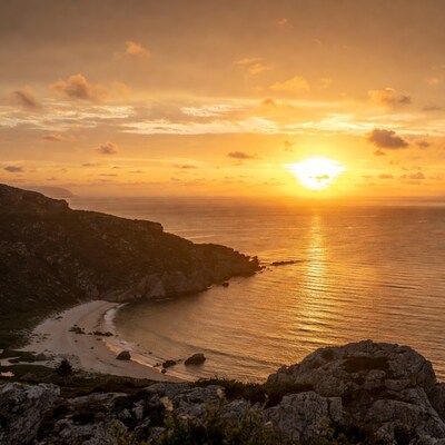 Sunset over coastal cliffs and beach