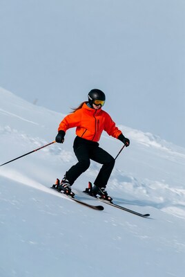 Woman skiing down snowy slope