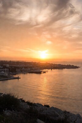 Sunset over coastal town harbor