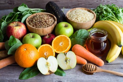 Fresh fruits grains vegetables on wooden table