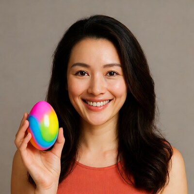 Asian woman holding rainbow Easter egg