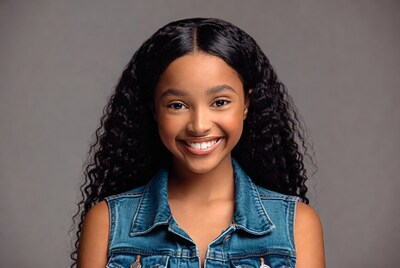 Smiling African-American girl in denim vest