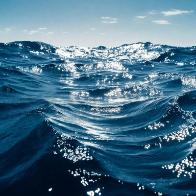 Sparkling Ocean Waves Under Blue Sky