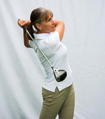 Woman swinging golf club