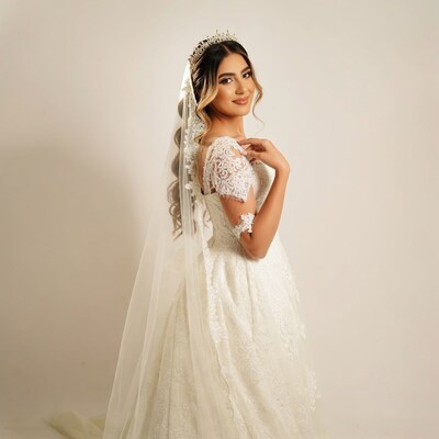 Bride in lace wedding gown with veil