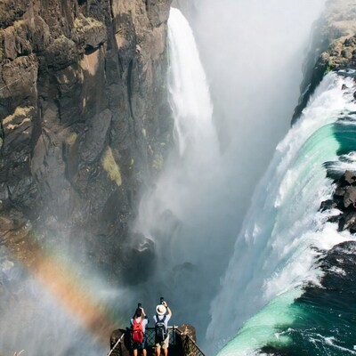 Couple viewing Victoria Falls rainbow