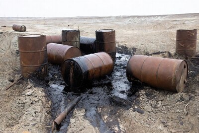 Rusty oil drums leaking in desert