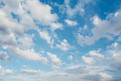 Fluffy white clouds in blue sky