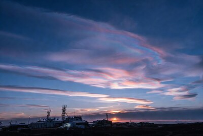 Sunset over industrial buildings and clouds