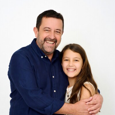 Father hugging smiling daughter