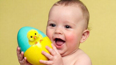 Baby holding chick Easter egg