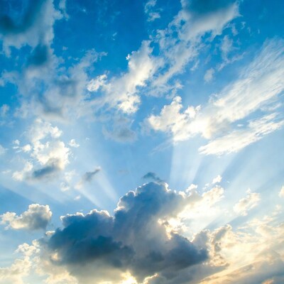 Sun rays through blue clouds