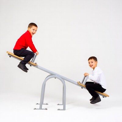 Two boys playing on seesaw
