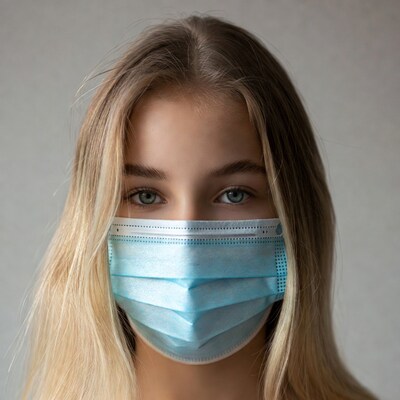 Blonde girl wearing blue face mask