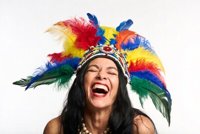 Woman laughing in colorful feather headdress