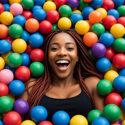 African-American woman laughing in colorful ball pit