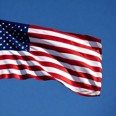 American Flag Waving Against Blue Sky