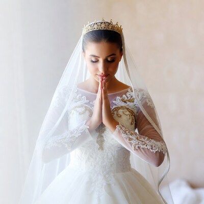 Bride praying with hands clasped