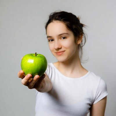 Girl holding green apple