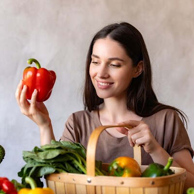 Woman holding red bell pepper