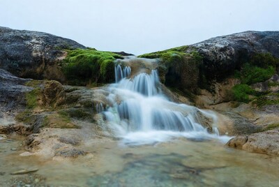Waterfall cascading over mossy rocks