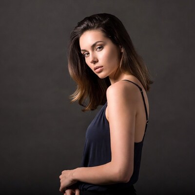Woman in black tank top profile view