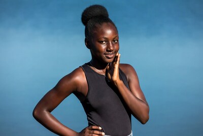 African girl hand on cheek smiling