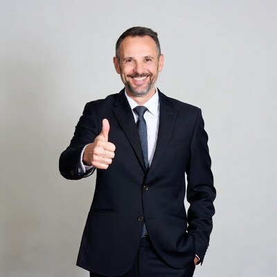 Smiling man in suit giving thumbs up