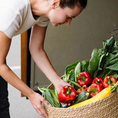 Woman picking vegetables from basket